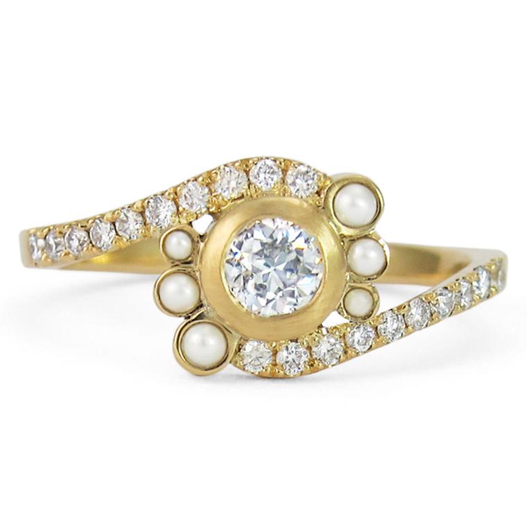 Jessica Poole diamond engagement ring encircled by six pearls and a pavé diamond band.